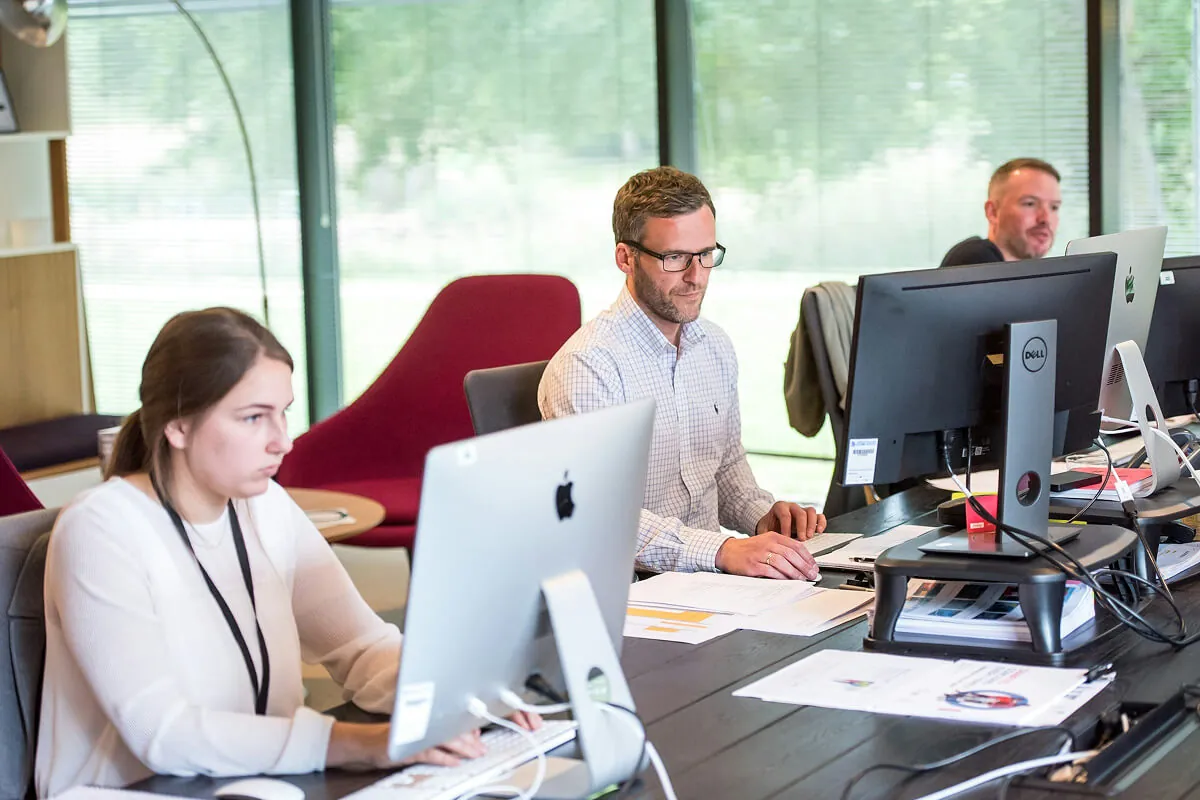 ai agent development solutions — team collaborating on whiteboard - Photo by Moe Magners on Pexels