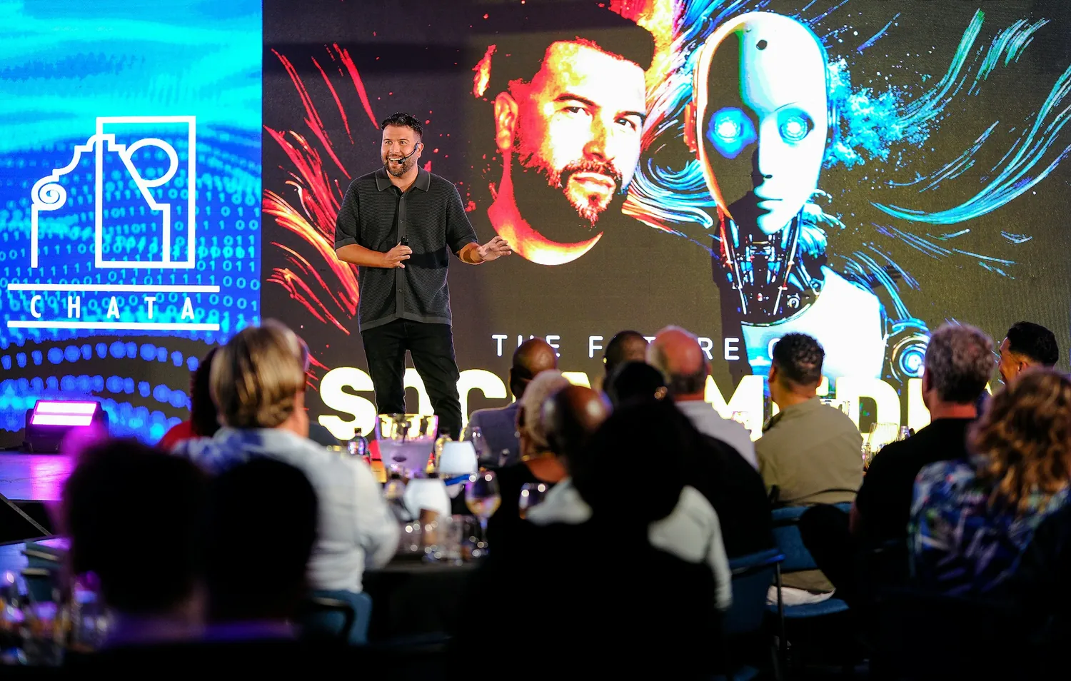 A speaker on stage presenting a slide about the future of social media to a seated audience