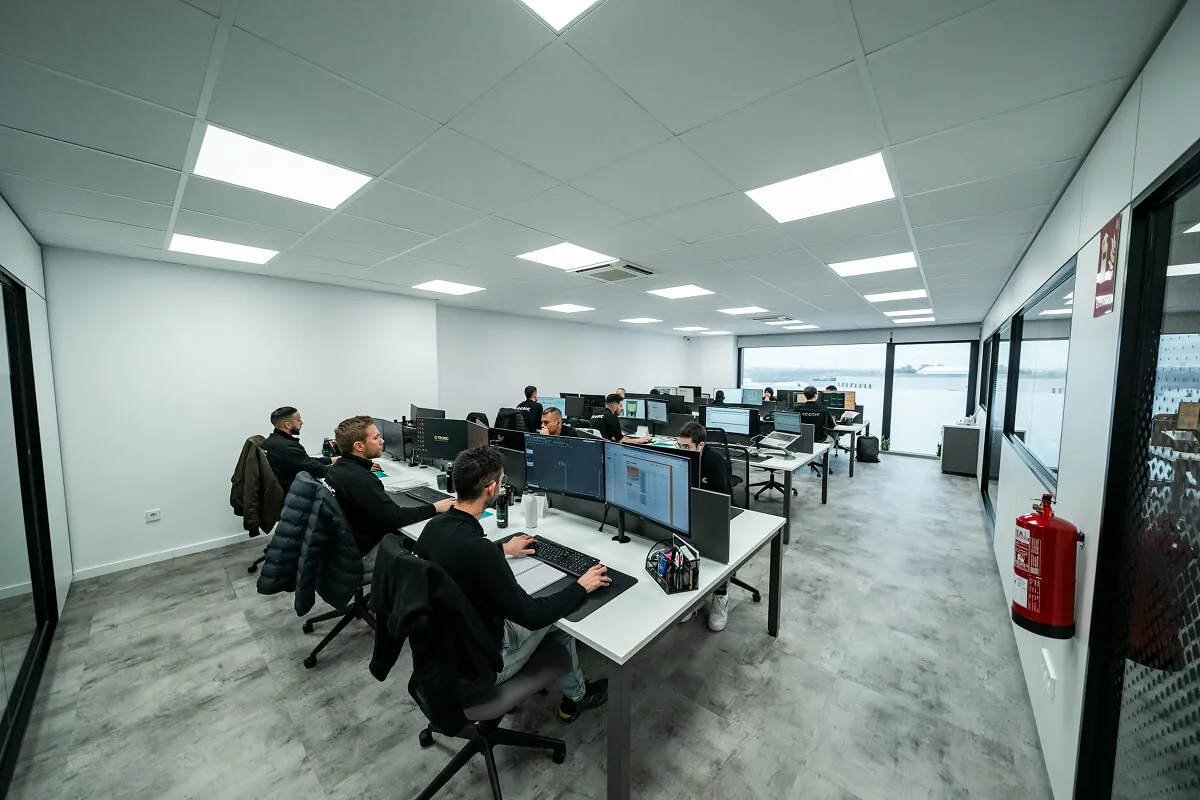 Alt text: Developers working in a modern office workspace.