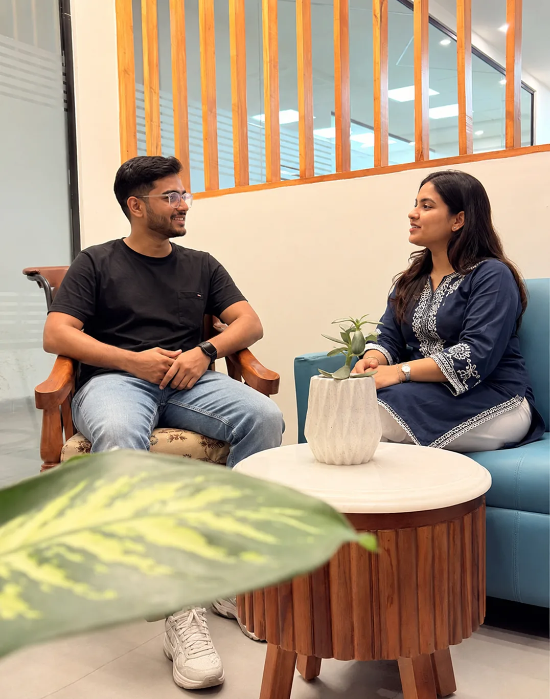 Two PixlerLab AI development team members talking in the office lounge